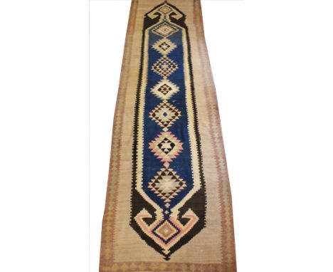 A geometric wool runner, with central medallions in a nomadic design, in blue, brown, oatmeal and pink colourways, 490cm x 13