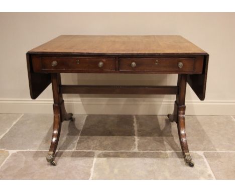 A George IV mahogany sofa table, the rectangular top with drop leaves, over two frieze drawers opposed by faux drawers, raise