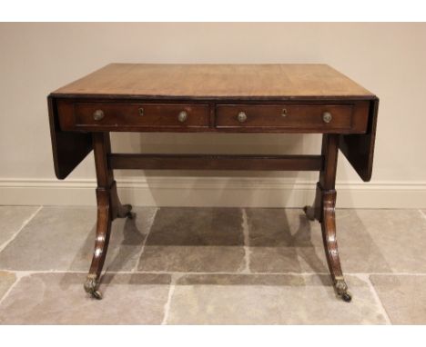 A George IV mahogany sofa table, the rectangular top with drop leaves, over two frieze drawers opposed by faux drawers, raise