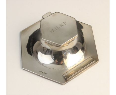 A George V silver capstan inkwell by Walker &amp; Hall, Sheffield 1922, of hexagonal form with hinged cover and pen rest, cle