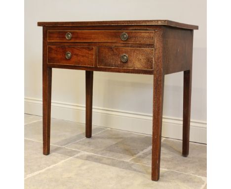 A George III mahogany side table, with an arrangement of one long and two short drawers, applied with gilt metal wreath ring 