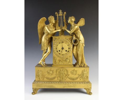 A late 19th century French Empire style gilt metal mantel clock, the case surmounted with classical figures flanking a lyre a
