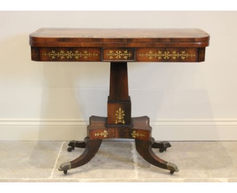 A George IV rosewood and brass inlaid card table, the rectangular top with rounded corners enclosing a baize lined interior, 