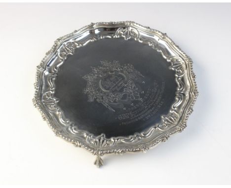 A Victorian silver salver by Martin, Hall &amp; Co, London 1890, of circular from with beaded and embossed border on three ba