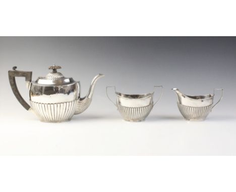 A George V three-piece silver tea service by Charles S Green & Co Ltd, Birmingham 1925, comprising teapot, sugar bowl and mil