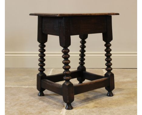 A 17th style oak joint stool, early 20th century, the rectangular moulded board seat upon bobbin turned and block supports, u