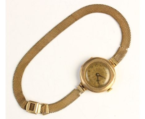 A lady's 9ct gold vintage wristwatch, the round dial with Arabic numerals and engine turned decoration, set to a plain polish