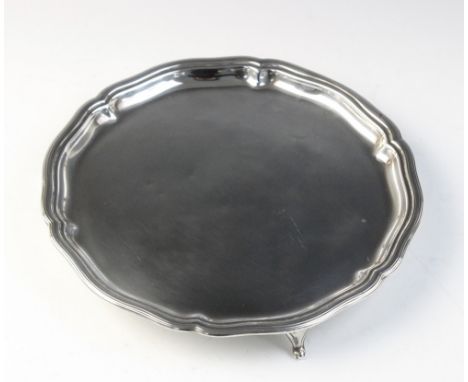 A George V silver salver by William Hutton &amp; Sons, Sheffield 1925, of circular form with shaped reeded border on three pa