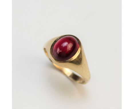 A ruby set dress ring, the central untested oval cabochon ruby measuring 10mm x 8mm (assessed and assumed as synthetic), set 