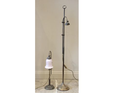 A gilt metal floor standing reading lamp, 20th century, the circular weighted plinth base extending to an adjustable reeded c