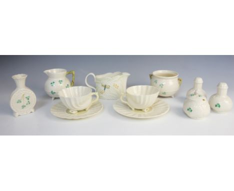 A collection of Belleek china, mid 20th century, comprising: two shell cups and saucers, a 'Shamrock' pattern cruet set, with