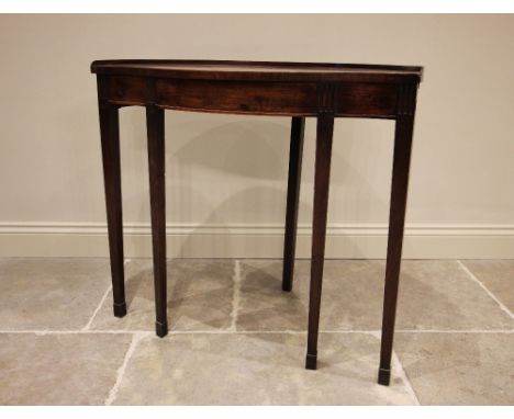 An unusual George III, serpentine fronted, mahogany demi-lune console table, raised on four fore-legs of tapered square secti