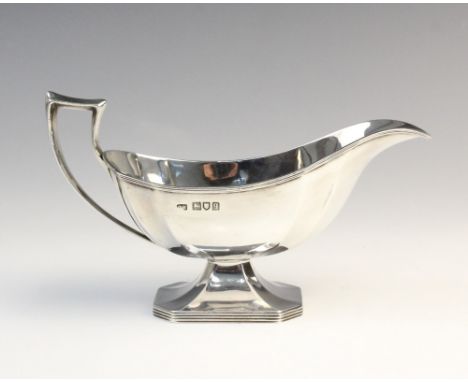 A George V silver sauce boat by Harrison Brothers &amp; Howson, London 1911, of faceted form on raised octagonal foot, 9.8cm 