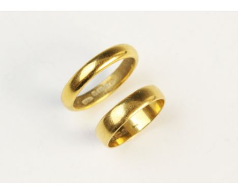 A 22ct gold wedding band, marks for Birmingham 1922, ring size M 1/2 together with another example, marks for Birmingham 1960