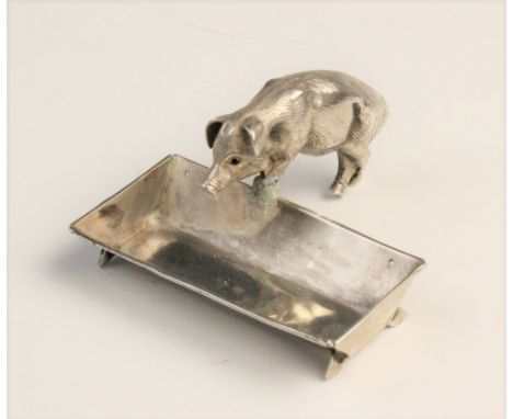 A novelty silver open salt, Chester circa 1900, realistically modelled as a pig and trough, the trough measuring 4.9cm x 2.9c