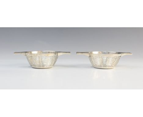 A pair of George V silver twin-handled bon bon dishes by Stewart Dawson &amp; Co Ltd, Birmingham 1910, each of circular form 