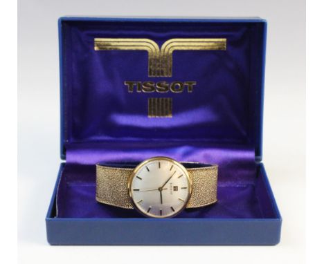 A Gent's vintage 9ct gold Tissot wristwatch, the circular silver dial with baton markers, set to a plain polished 9ct gold ca