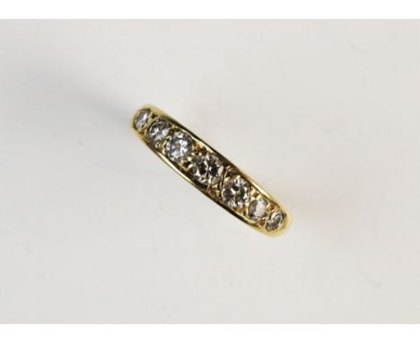 A diamond seven stone 18ct gold ring, comprising seven graduated round brilliant cut diamonds, (estimated measurements betwee