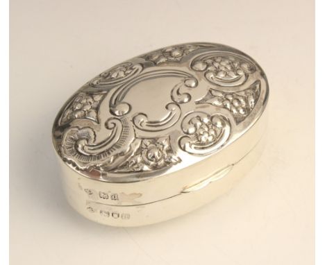 A Victorian silver pill box by William Hutton &amp; Sons, London 1899, of convex oval form, the hinged cover with embossed fl