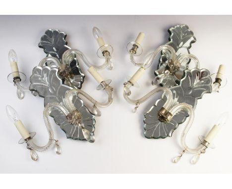 A set of four mirror back glass wall sconces, early 20th century each with twin 'S' shaped glass branches, along with a furth