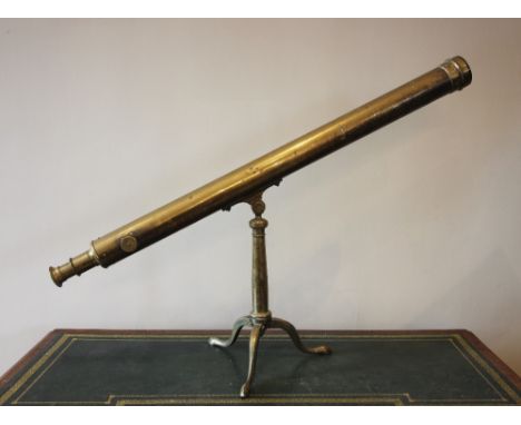 A brass telescope, late 19th/early 20th century, mounted on a tapering brass column with hinged tripod legs, the telescope 10