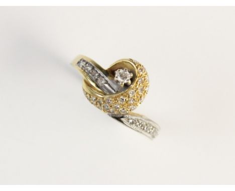 A diamond set 18ct gold ring, the principle round brilliant cut diamond (weighing an estimated 0.05 carats) claw set to a yel