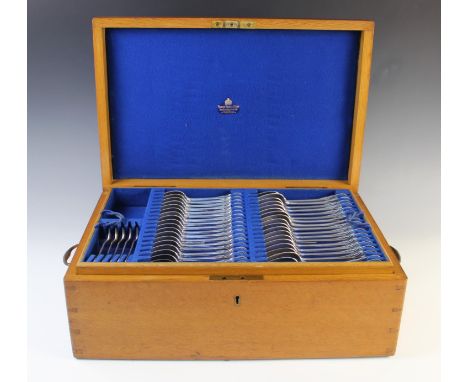 An Edwardian oak cased canteen of cutlery by Manoah Rhodes &amp; Sons, early 20th century, comprising: eighteen small forks, 