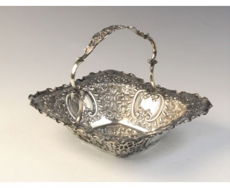 An Edwardian silver swing-handled sweetmeat basket by Martin, Hall &amp; Co, Sheffield 1903, of rectangular form with moulded