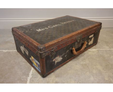 An early 20th century Louis Vuitton suitcase, number 806303 within internal lift-out tray, titled 'Mrs Carl Bendix', with tra