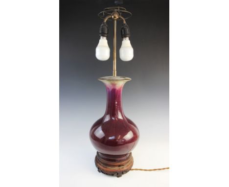 A Chinese porcelain flambe glazed vase, 19th century, the baluster shaped vase with a graduating aubergine/purple hue glaze t