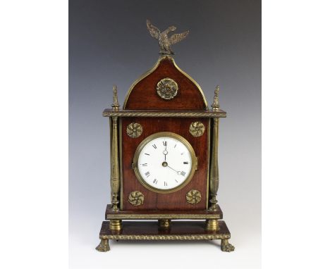 A 19th century Regency mahogany cased architectural mantel timepiece of ogee form, the 9cm white enamel dial with black Roman