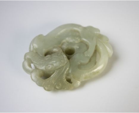 A Chinese jade bi disc, 19th century, the circular pale green disc carved with a scrolling Chilong, the underside with pebble