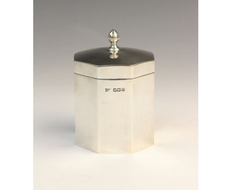 A George V silver tea caddy by Walker &amp; Hall, Sheffield 1922, of octagonal form with hinged cover and faceted finial, gil