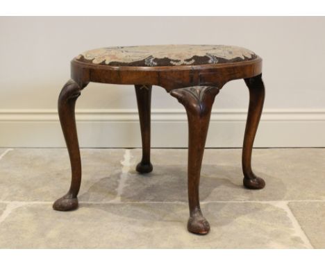 A George II style walnut oval dressing stool, in the manner of William Charles Tozer, the upholstered tapestry seat raised up