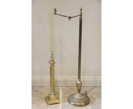 A gilt metal floor standing reading lamp, 20th century, the circular weighted plinth base extending to a reeded column and hi