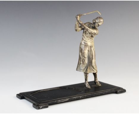 Golfing interest; An Art Deco Ronson desk stand, modelled as a nickel-plated lady golfing, supported upon a stand with a rese