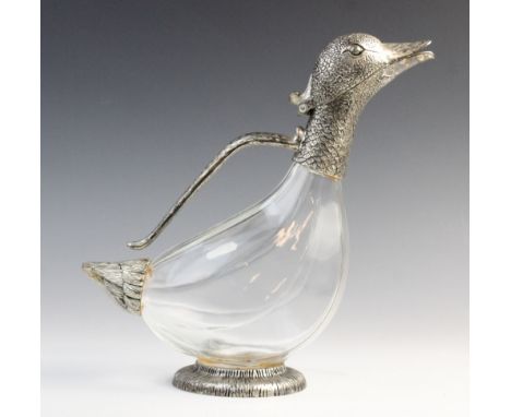 A novelty claret jug, modelled as a duck with faceted glass body and white metal mounts, the spout modelled as a duck's head 