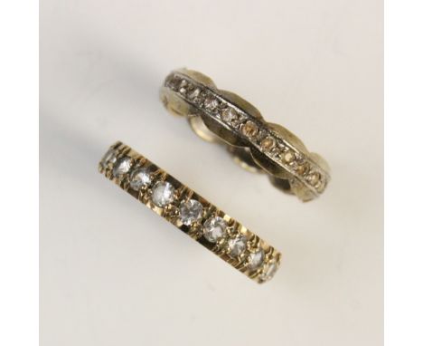 A 9ct gold white sapphire set eternity ring, comprising twenty-one round brilliant cut white sapphires, all set yellow gold, 