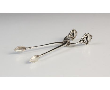 A pair of Georg Jensen silver acorn pattern sugar nips, import marks for Stockwell &amp; Co, London 1928, 9.4cm long Provenan