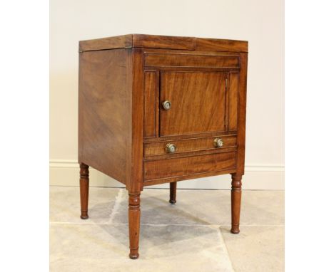 A George III and later mahogany cellarette, converted from a commode chest, the twin hinged top opening to an eight bottle co