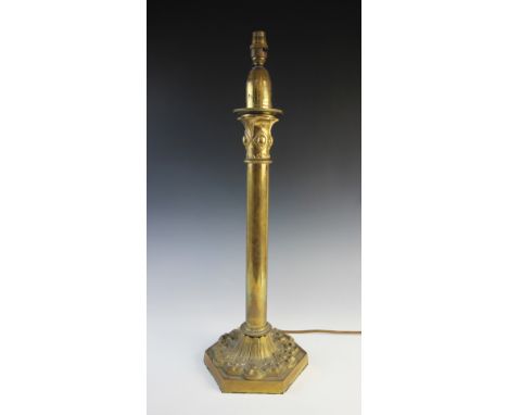 A late 19th century brass table lamp, stamped Palmer & Co, later converted to electricity, the Puginesque column raised upon 