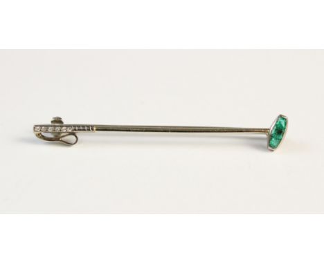 An emerald and diamond set bar brooch in the form of a polo mallet, the head set with three step cut emeralds, the handle set