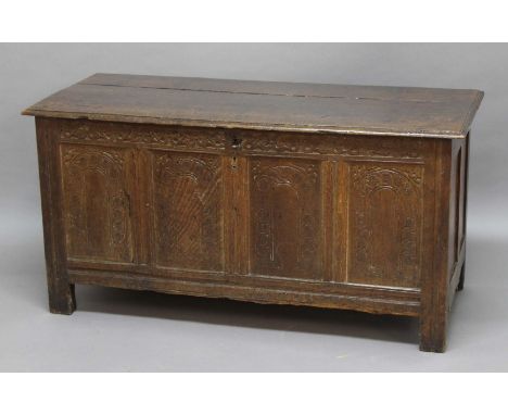 OAK COFFER, late 17th century, the hinged cover enclosing a vacant interior above a quadruple panel front with arched and fol