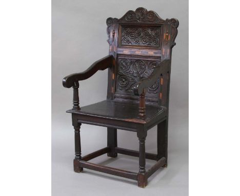 OAK AND INLAID WAINSCOT CHAIR, 17th century and later, the arched back with foliate carved top rail and two panel and inlaid 