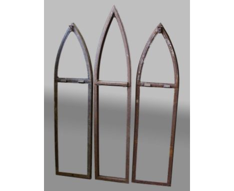 SEVEN IRON GOTHIC STYLE LANCET WINDOW FRAMES, six with hinged top lights, 2 @ 155cm x 32cm; 3 with top light @ 142cm x 36cm, 