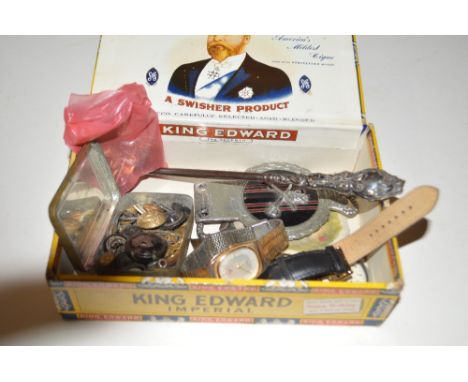 A cigarette box containing a silver handled button hook, wrist watches, Ingersoll pocket watch etc.