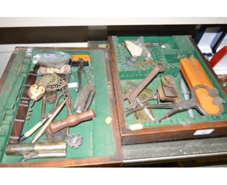 Two trays containing a pen knife; 19th Century corkscrews; a caddy spoons; starting pistol; a rosewood cased travelling knife