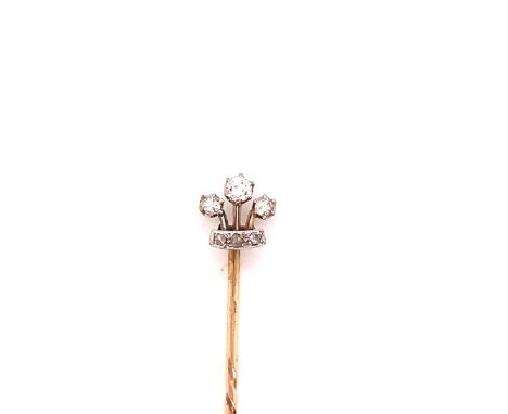 AN ANTIQUE DIAMOND CORONET STICK PIN. THE CORONET MOUNTED IN SILVER AND SET WITH SIX MIXED CUT DIAMONDS IN CLAW AND GRAIN SET