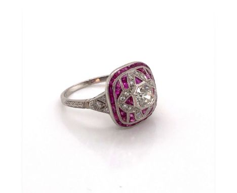 AN ANTIQUE STYLE PLATINUM, RUBY AND DIAMOND COCKTAIL RING. THE CENTRAL DIAMOND AN OLD CUT, WITH APPROX WEIGHT 0.53cts,SURROUN