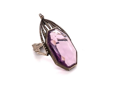 AN ART DECO WHITE METAL, MARCASITE AND AMETHYST PENDANT, FITTED WITH A HINGED OUTER FRAME. MEASUREMENTS 7.8cms X 3.1cms.